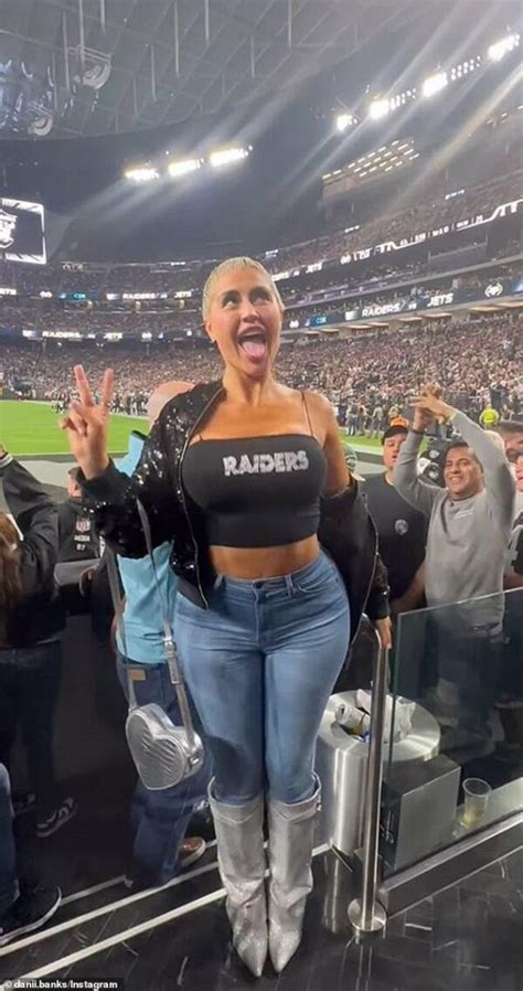 Model Danii Banks flashes in stands during NFL game and is